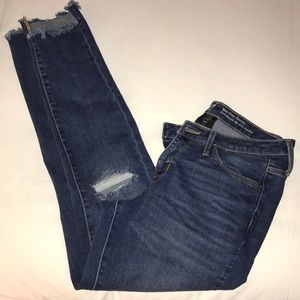 Trendy shaggy bottom ripped jeans